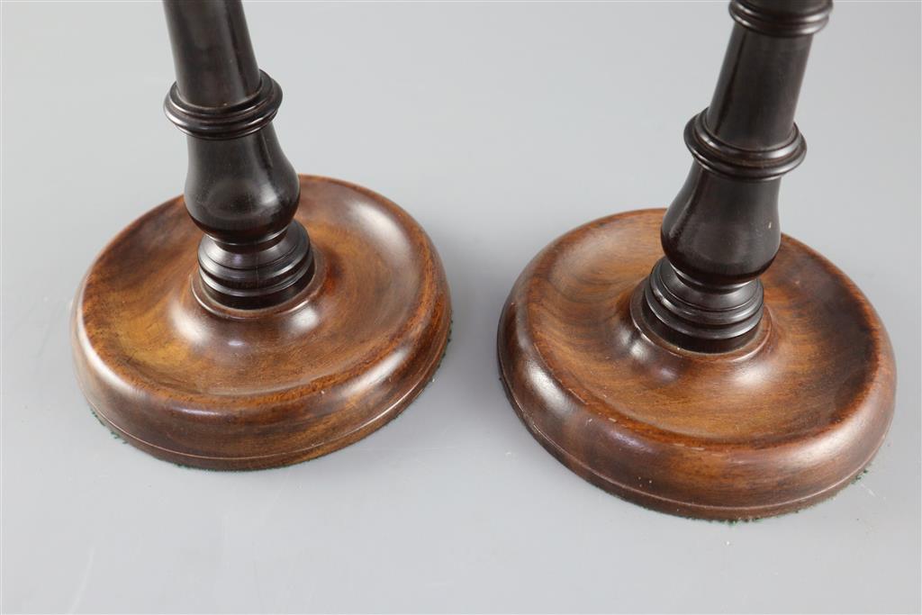 A pair of George III mahogany and ebony adjustable candle stands, height 8.75in.
